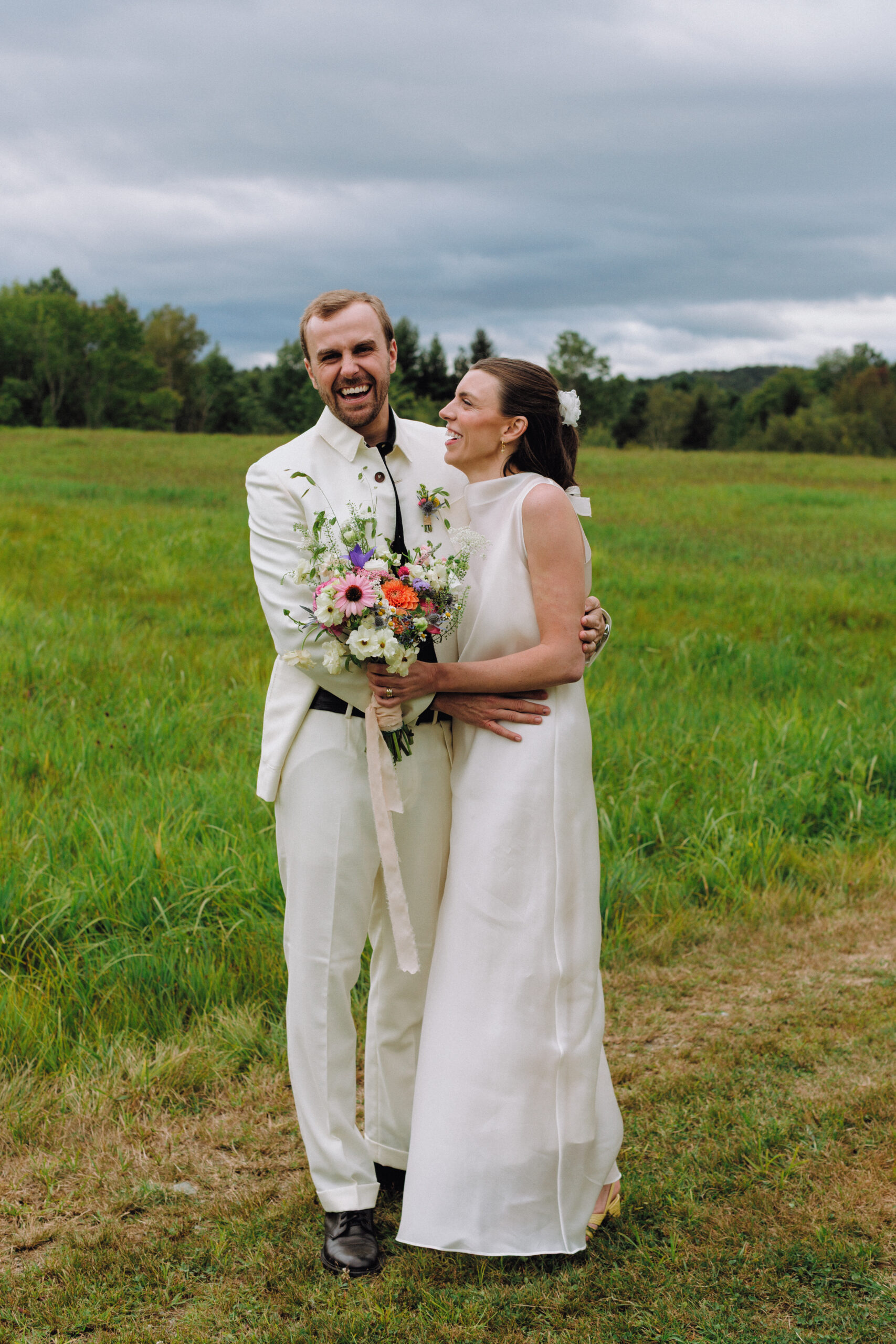 Couple lauging and celebrating their wedding at Bliss Ridge, Assorted Artistries Vermont Wedding Planner