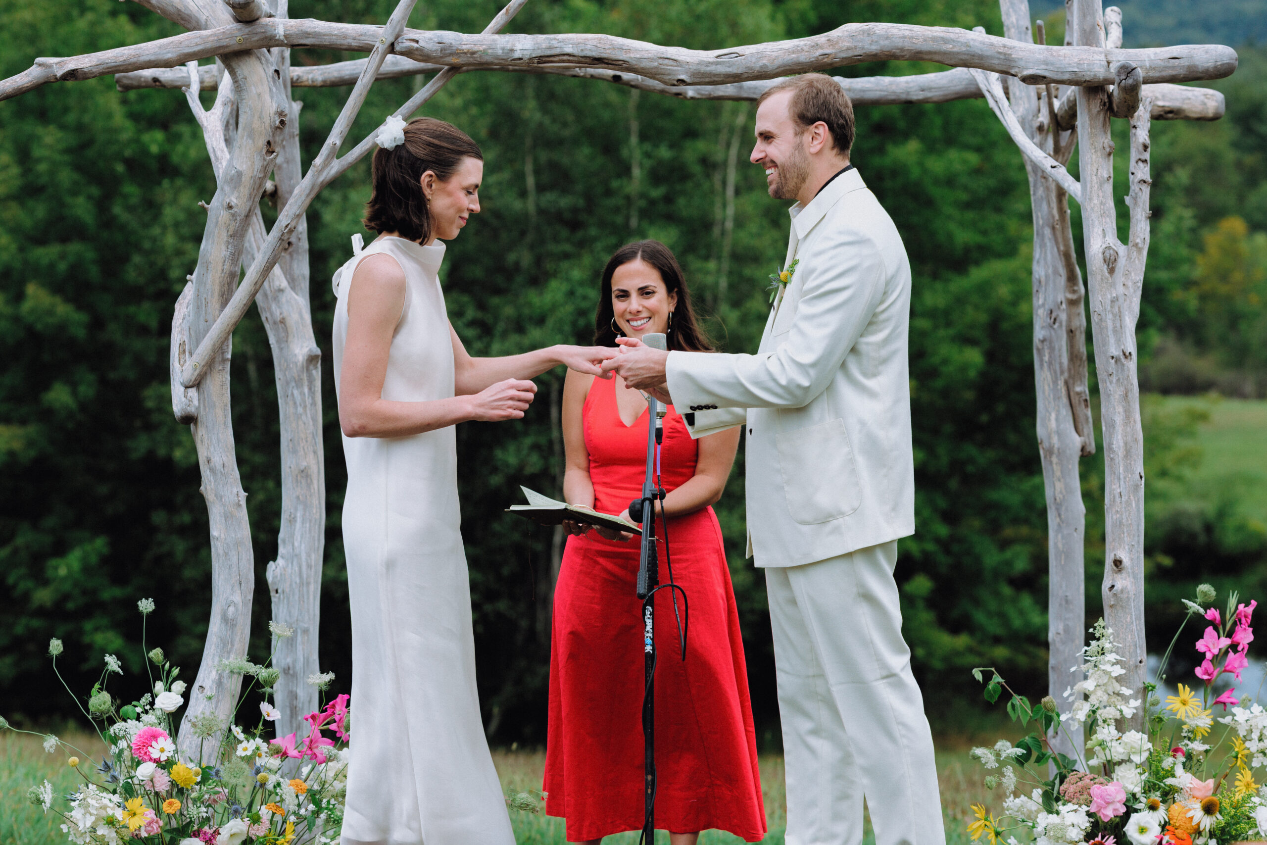 Ring exchange during their wedding at Bliss Ridge, Assorted Artistries Vermont Wedding Planner