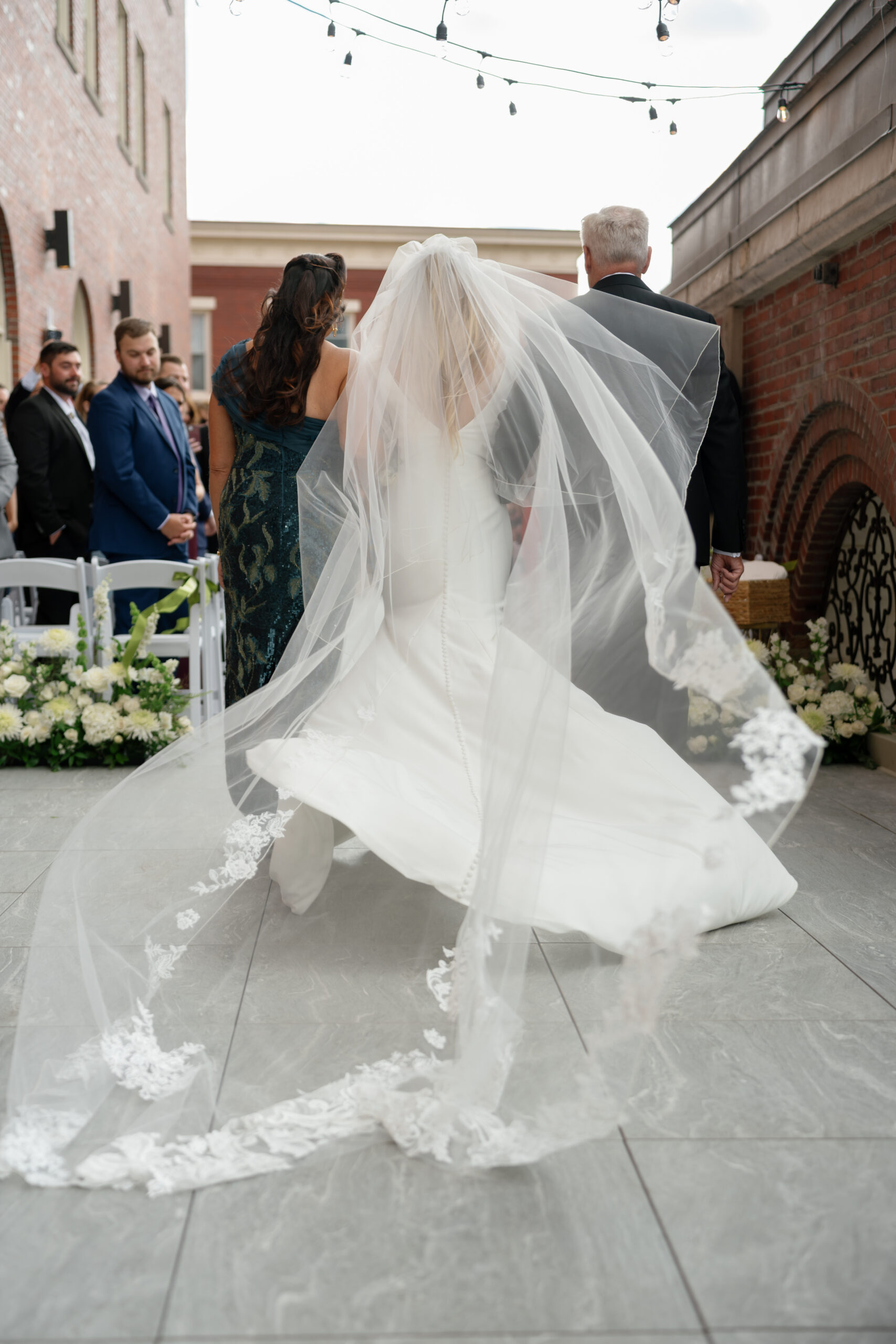 a brides veil billowing in the wind as she gets married in NY